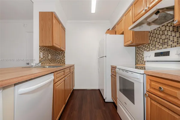 a kitchen with a sink stove and refrigerator