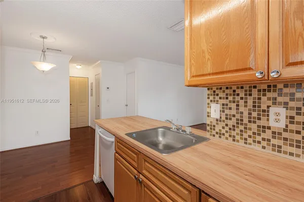 a kitchen that has a sink and a window in it