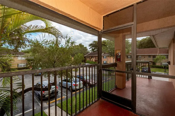 a view of a chairs and table in the balcony