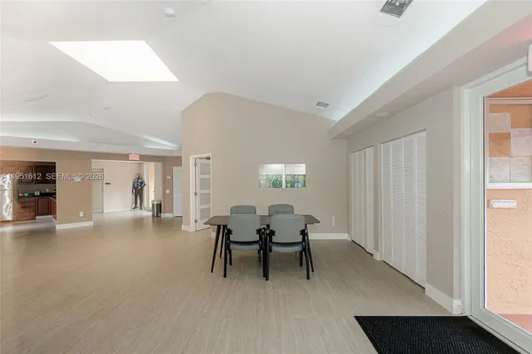 a dining room with furniture and window