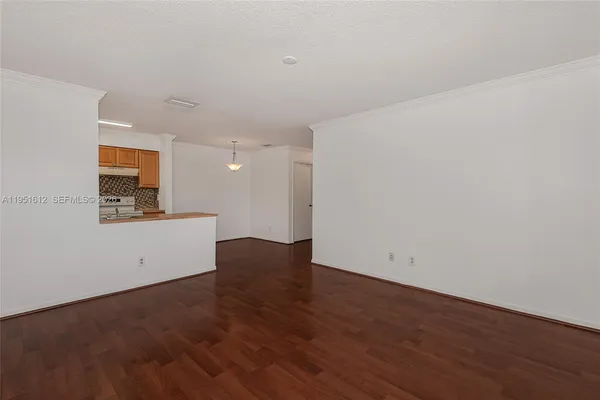a view of a kitchen with wooden floor and a sink
