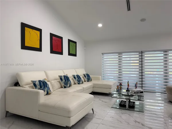 a spacious bedroom with a bed and a large mirror