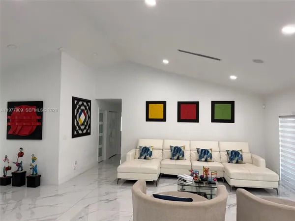 a large white bathroom with a shower and a sink