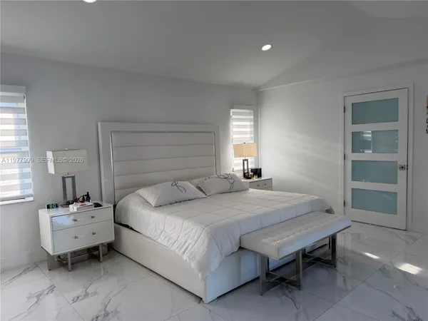 a living room with patio furniture and a potted plants