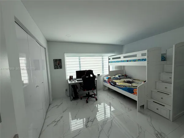 a living room with furniture a chandelier and a dining table