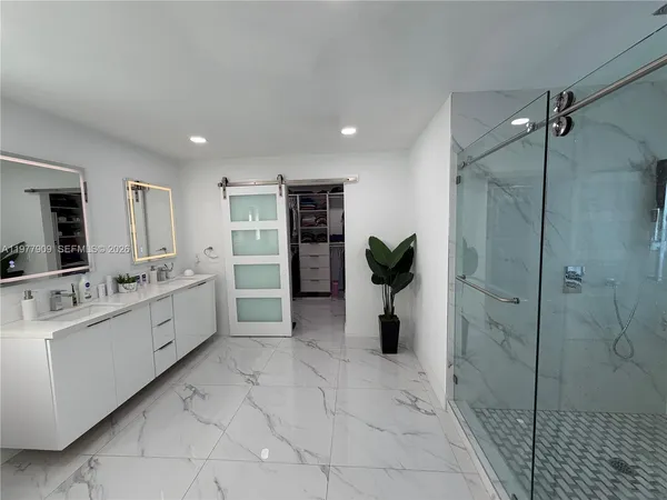 a living room with couch and a floor to ceiling window