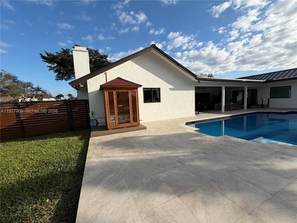 a living room with furniture a flat screen tv and a table