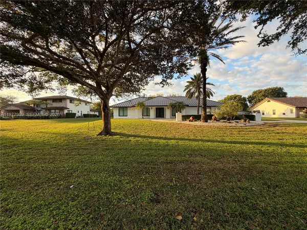 a view of a backyard with potted plants