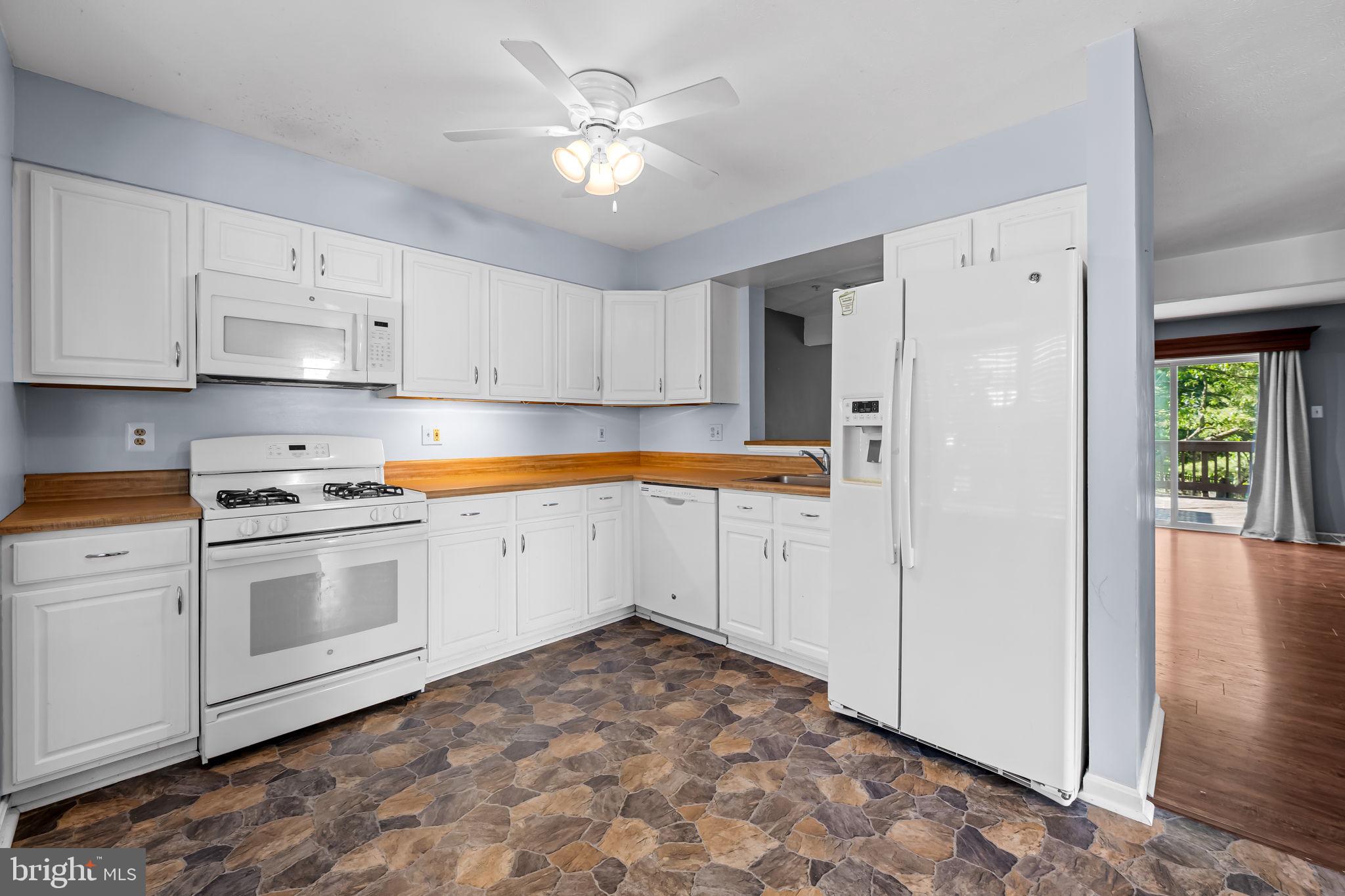 4630 Marksman Court Hampstead, MD 21074 - Photo 4 of 16 a kitchen with white cabinets and white appliances
