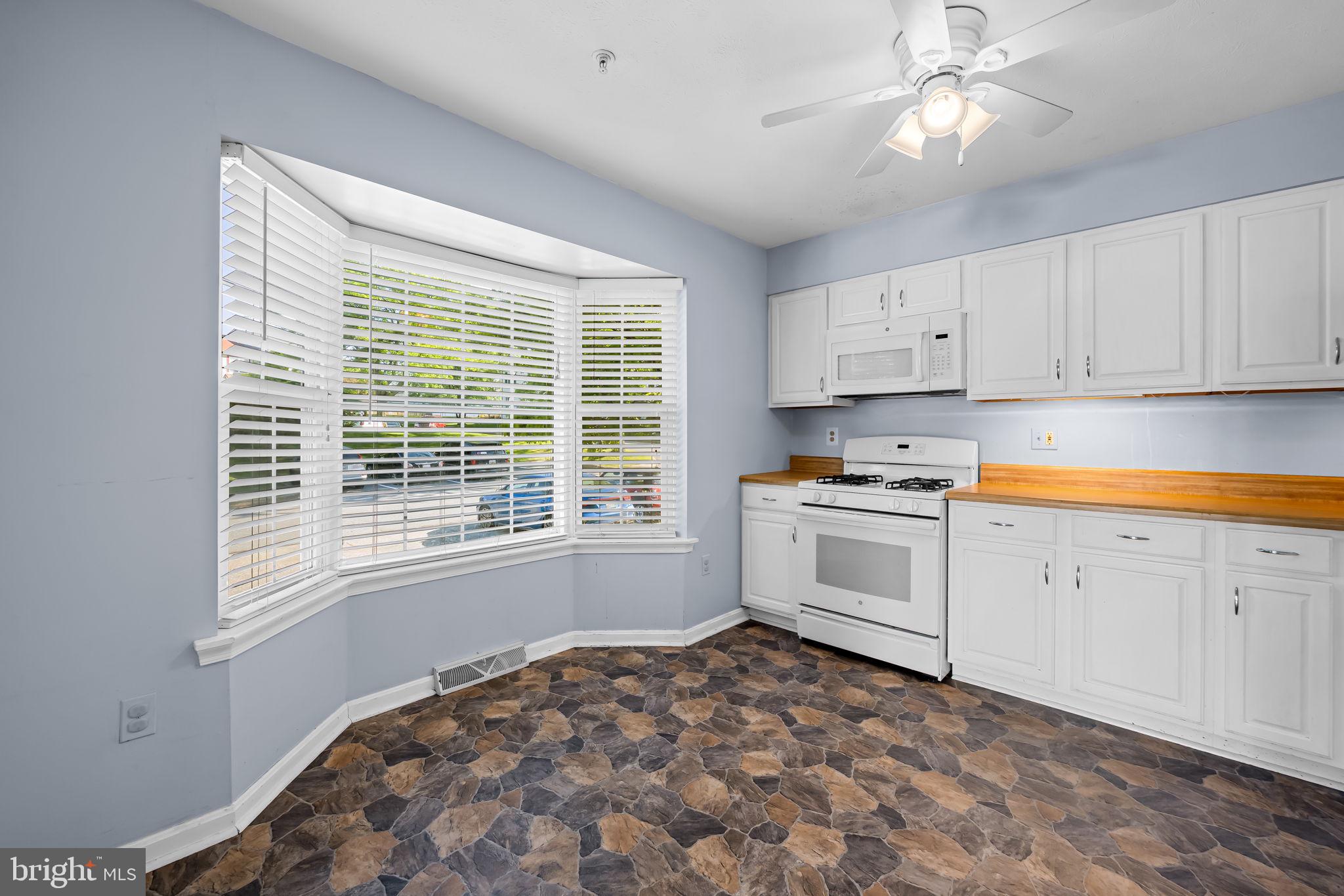 4630 Marksman Court Hampstead, MD 21074 - Photo 5 of 16 a kitchen with a stove window and cabinets