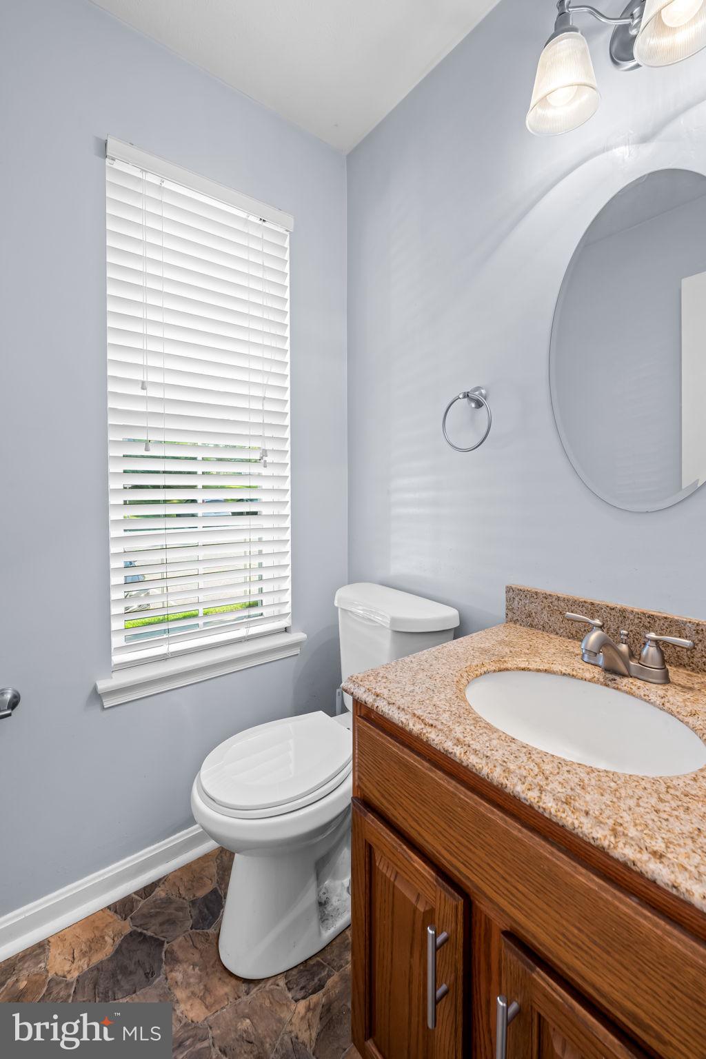4630 Marksman Court Hampstead, MD 21074 - Photo 8 of 16 a bathroom with a granite countertop toilet sink and mirror