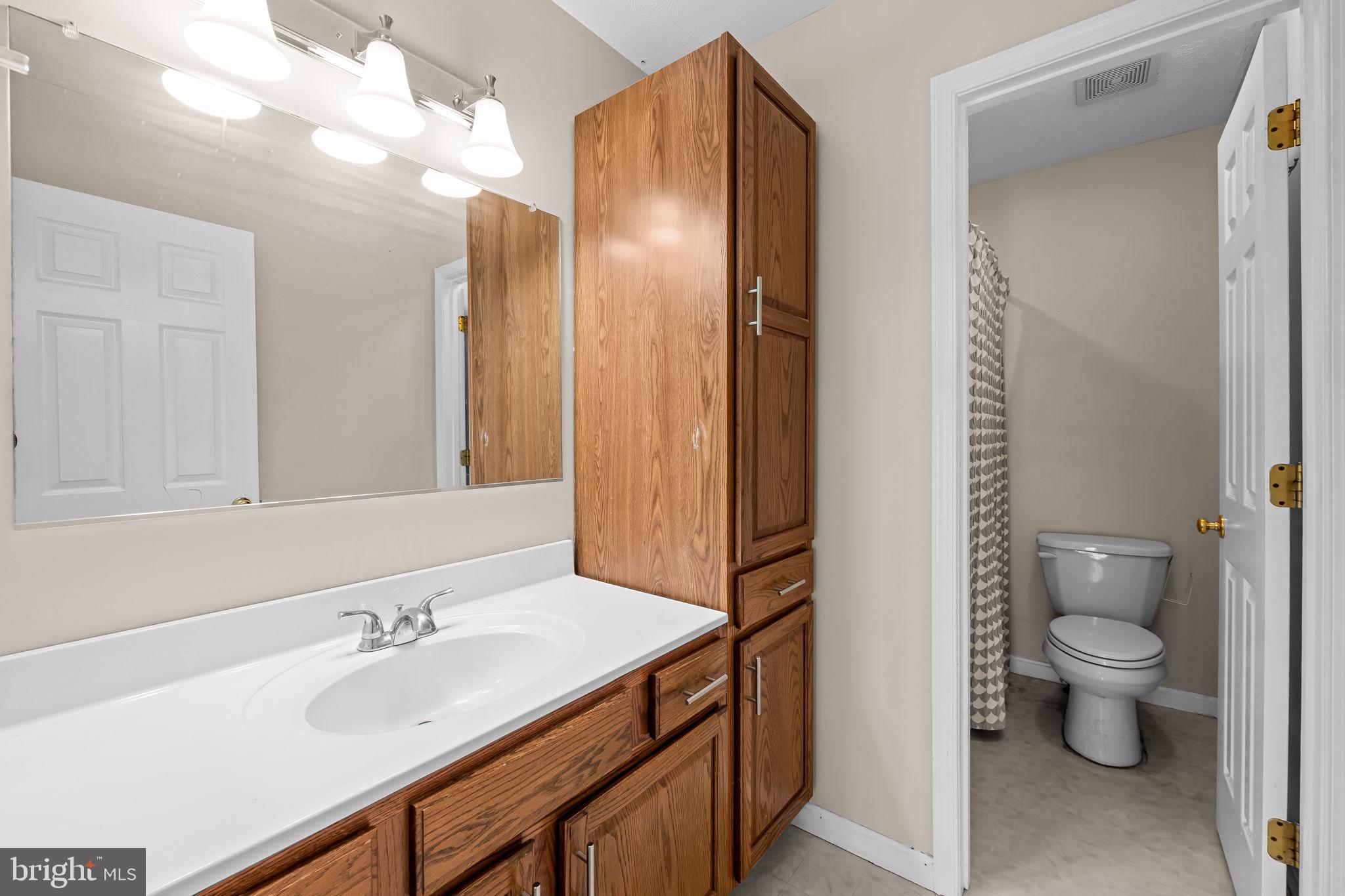 4630 Marksman Court Hampstead, MD 21074 - Photo 10 of 16 a bathroom with a granite countertop sink toilet and shower