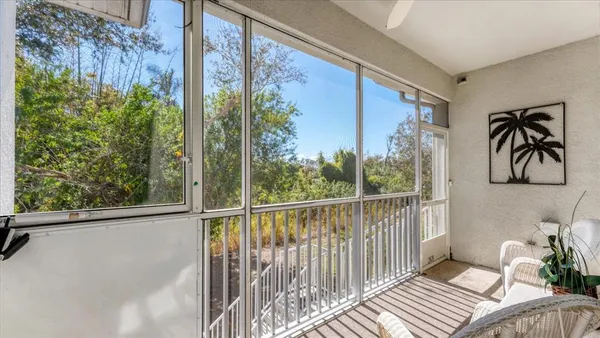 a view of a balcony with furniture