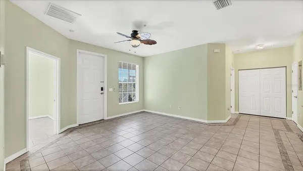 a view of an empty room with a fan