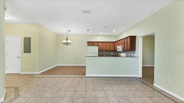 a view of kitchen with refrigerator and window