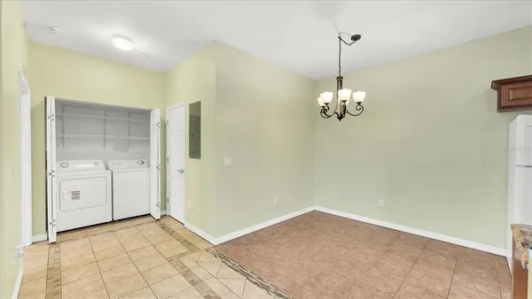 a view of a chandelier in big room and chandelier fan