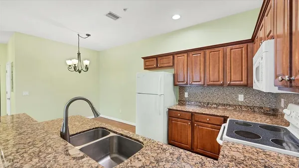 a kitchen with a sink stove and cabinets