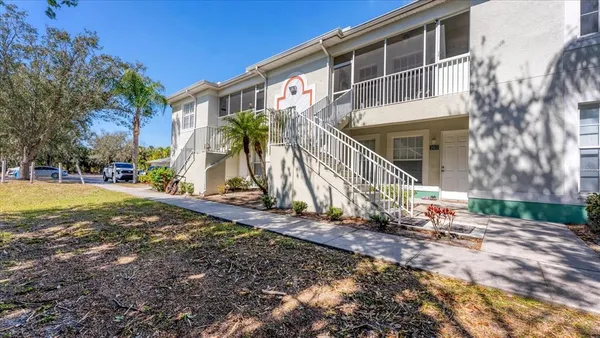 a view of a house with backyard and sitting area