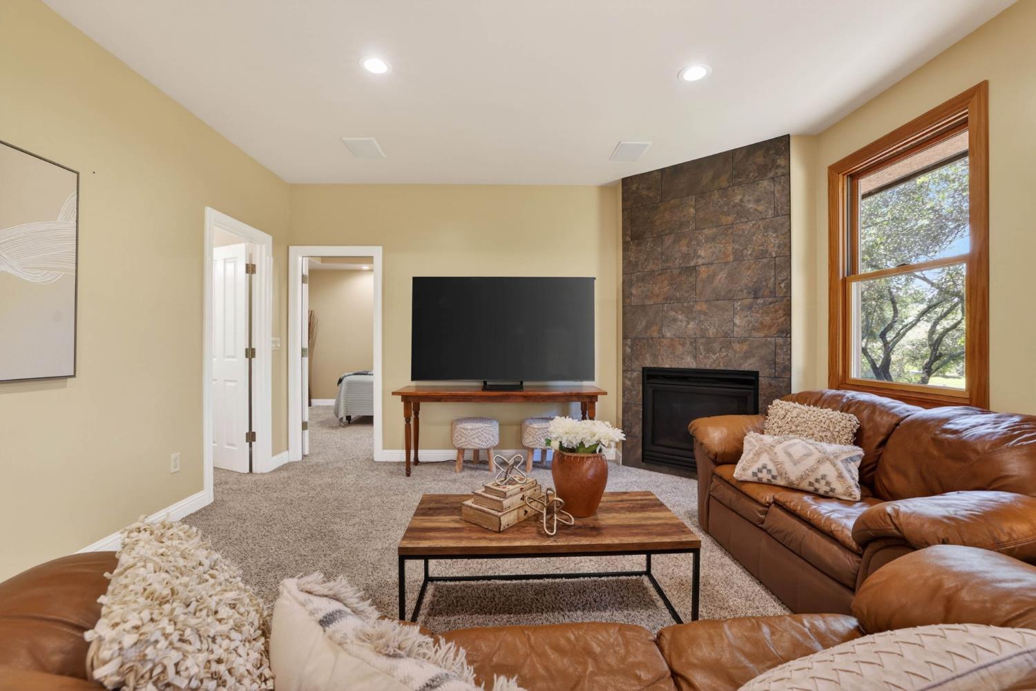 7021 Horseshoe Bar Road Loomis, CA 95650 - Photo 36 of 77 a living room with furniture a flat screen tv and a fireplace