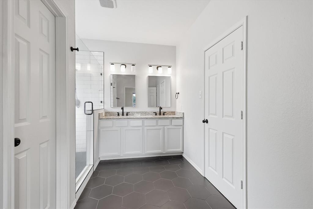 13236 Ridgepointe Road Fort Worth, TX 76244 - Photo 16 of 19 a bathroom with a double vanity sink mirror and