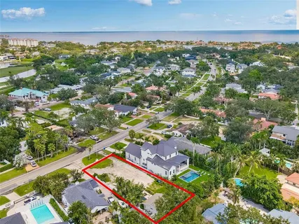 an aerial view of residential houses with outdoor space and street view