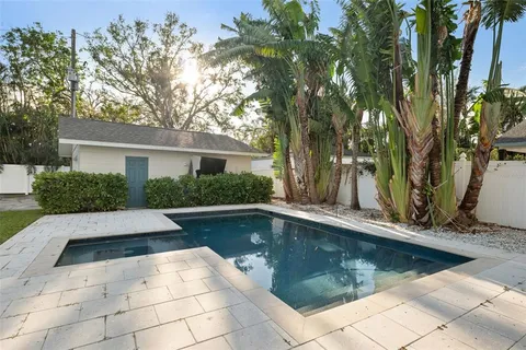 a view of a backyard with swimming pool
