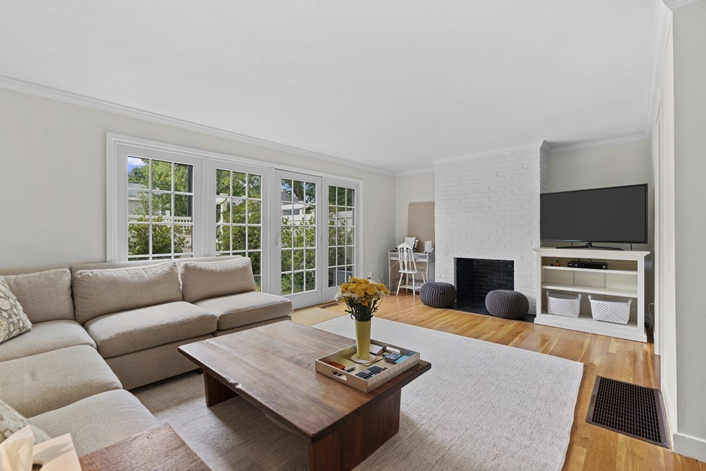 a living room with furniture and a view of kitchen