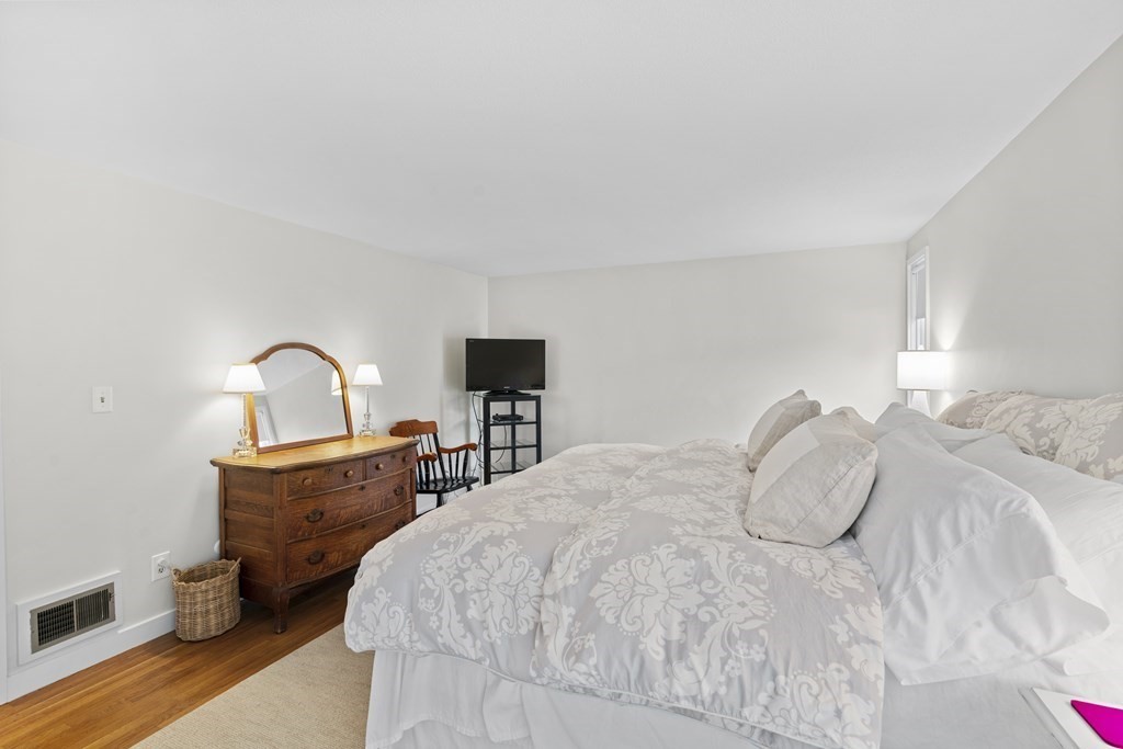 11 Oak Street, Unit 35 Wellesley, MA 02482 - Photo 11 of 22 a bedroom with a bed and a table