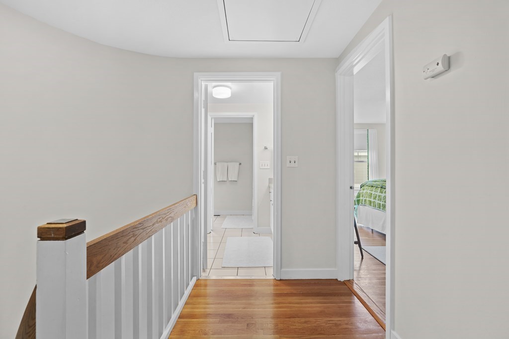 11 Oak Street, Unit 35 Wellesley, MA 02482 - Photo 12 of 22 a view of a hallway with wooden floor and staircase