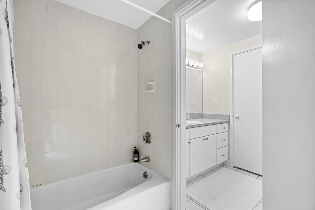 11 Oak Street, Unit 35 Wellesley, MA 02482 - Photo 15 of 22 a bathroom with a tub sink shower and mirror
