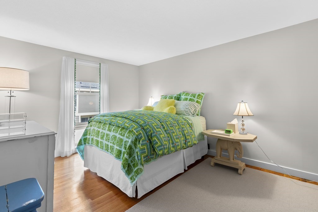 11 Oak Street, Unit 35 Wellesley, MA 02482 - Photo 17 of 22 a bedroom with a bed and a table in it