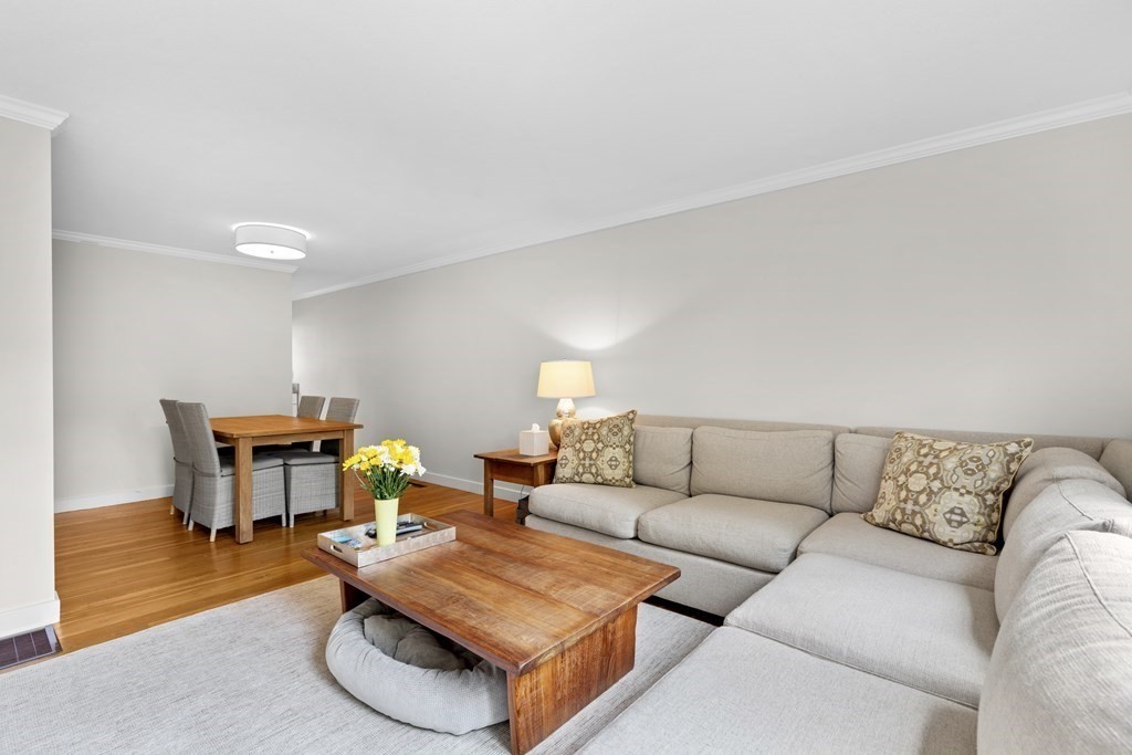 11 Oak Street, Unit 35 Wellesley, MA 02482 - Photo 2 of 22 a living room with furniture and a dining table