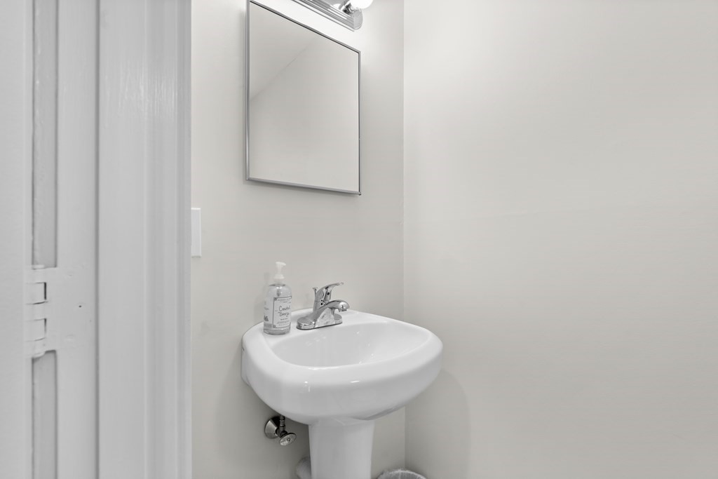 11 Oak Street, Unit 35 Wellesley, MA 02482 - Photo 7 of 22 a bathroom with a sink a mirror and a toilet