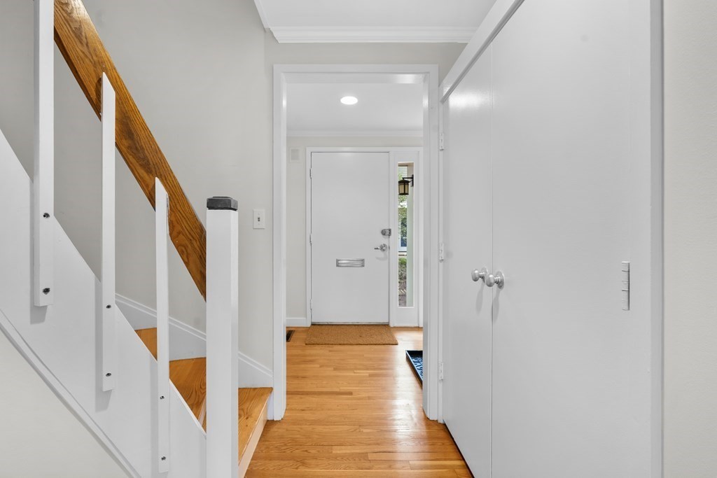 11 Oak Street, Unit 35 Wellesley, MA 02482 - Photo 8 of 22 a view of a hallway with wooden floor and staircase