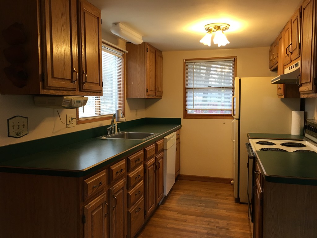 185 Shirley Road Lancaster, MA 01523 - Photo 4 of 15 a kitchen with stainless steel appliances granite countertop a sink stove and cabinets