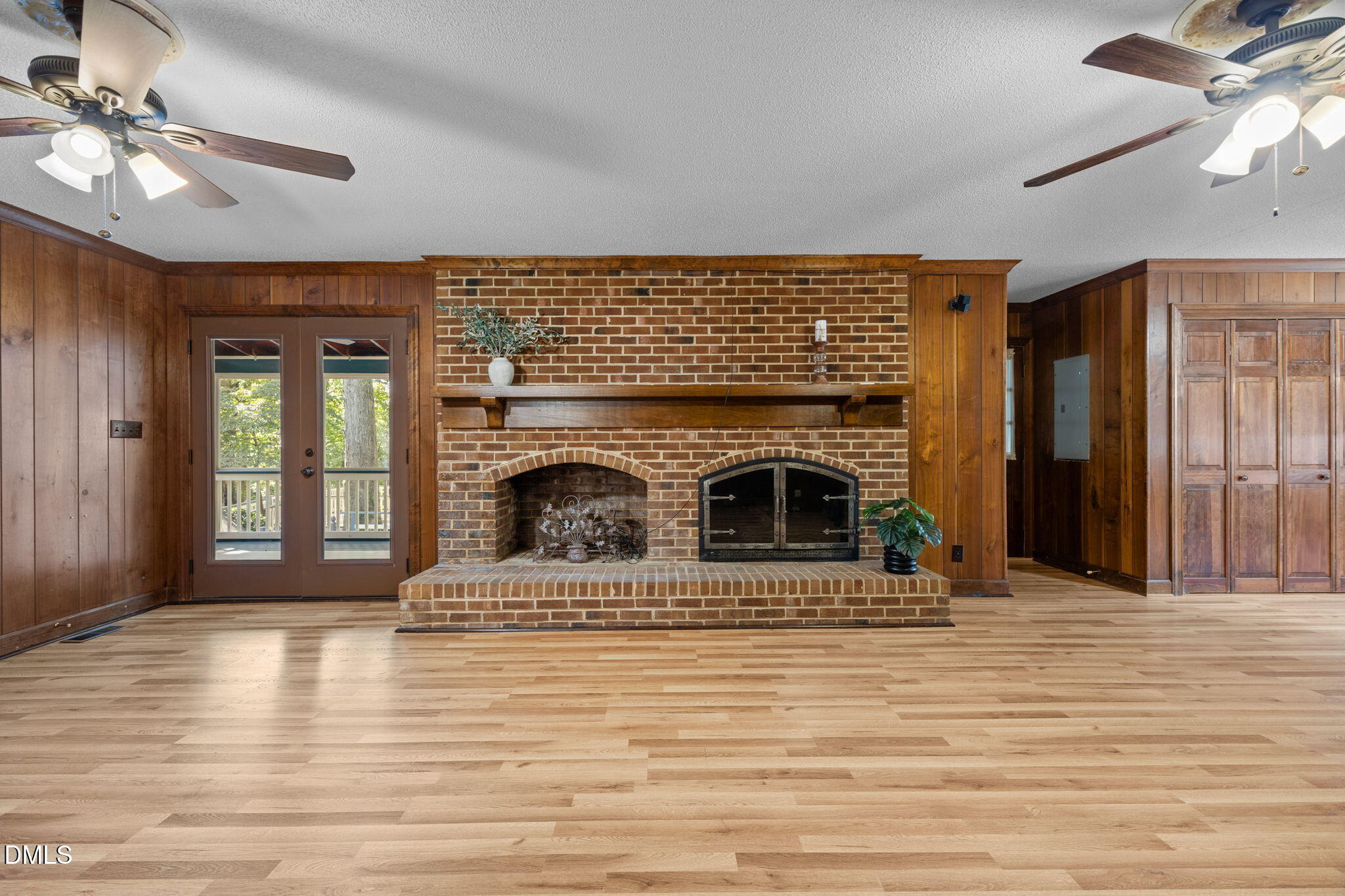 8701 Oneal Road Raleigh, NC 27613 - Photo 11 of 33 a living room with fireplace and a wooden floor