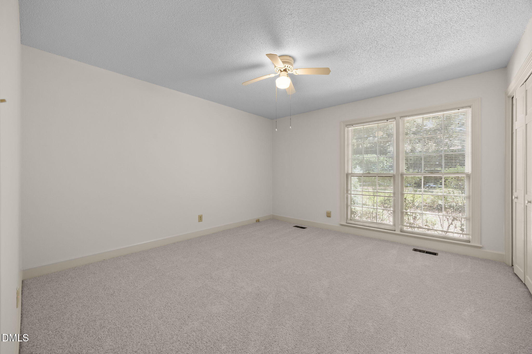8701 Oneal Road Raleigh, NC 27613 - Photo 19 of 33 an empty room with chandelier fan and window