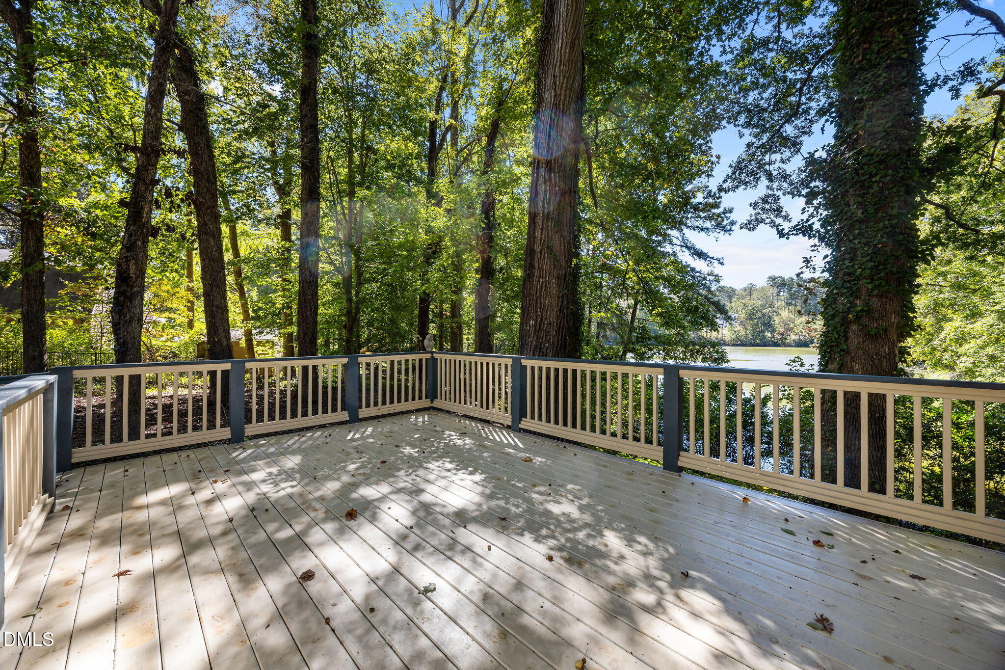 8701 Oneal Road Raleigh, NC 27613 - Photo 23 of 33 a view of balcony with wooden fence and trees