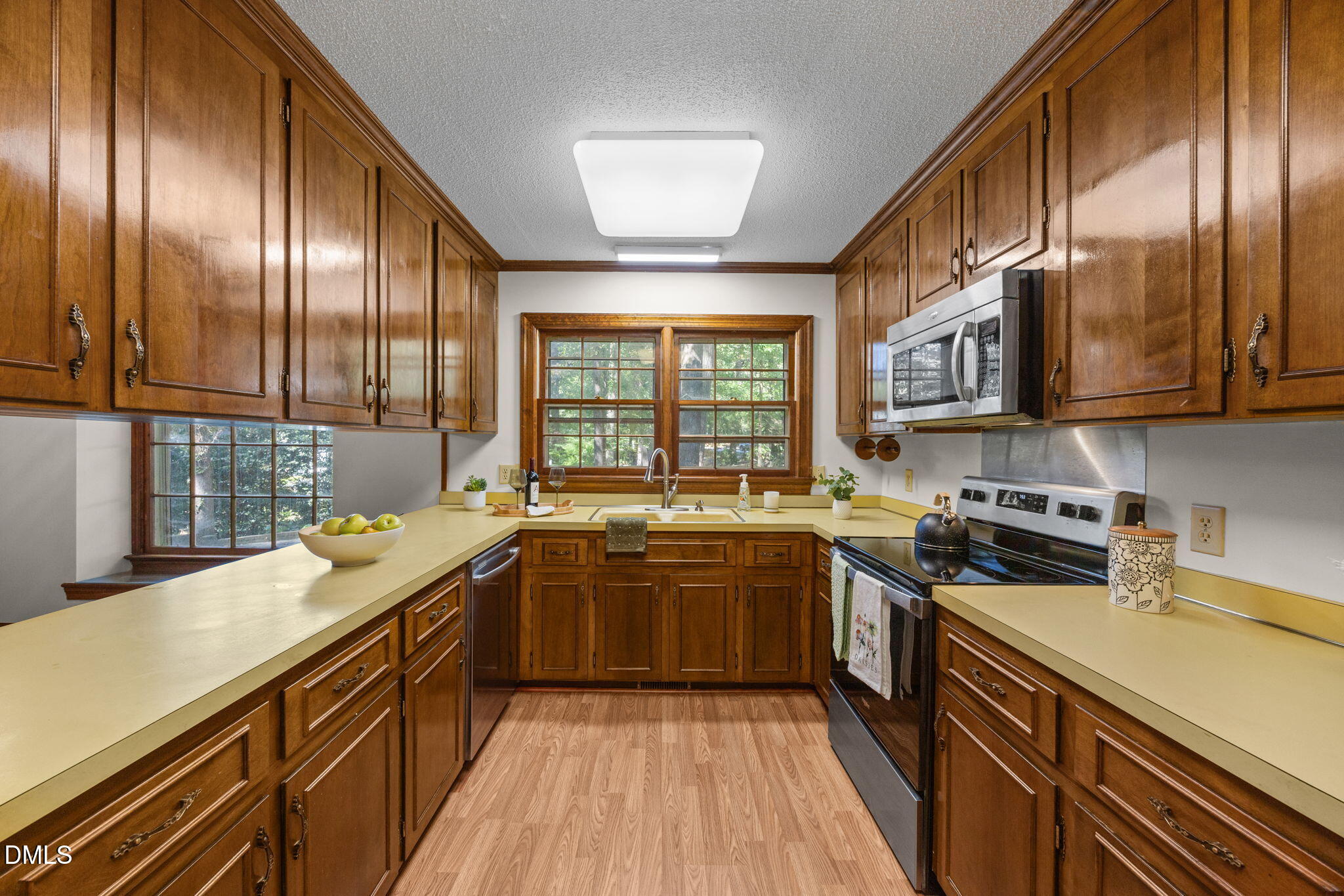 8701 Oneal Road Raleigh, NC 27613 - Photo 7 of 33 a kitchen with stainless steel appliances granite countertop hardwood floor sink stove and granite counter top