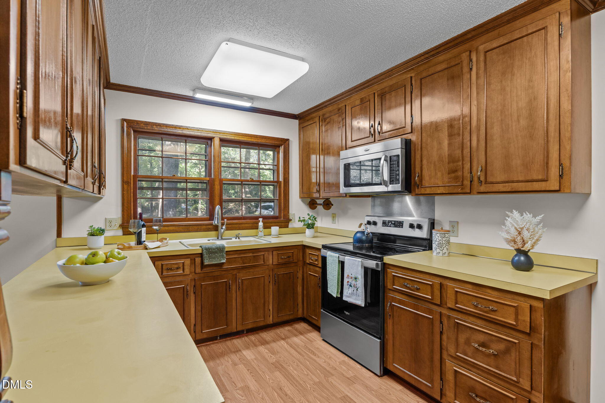 8701 Oneal Road Raleigh, NC 27613 - Photo 8 of 33 a kitchen with stainless steel appliances granite countertop a sink stove and cabinets