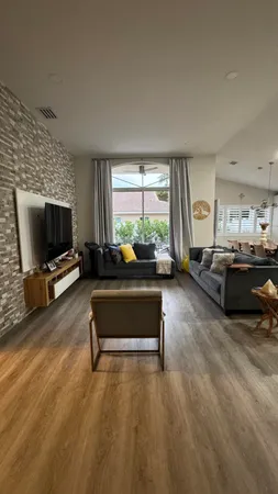 a living room with furniture window and a flat screen tv