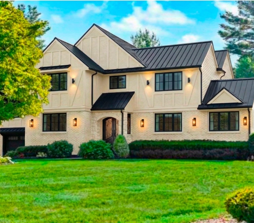 a front view of a house with a garden