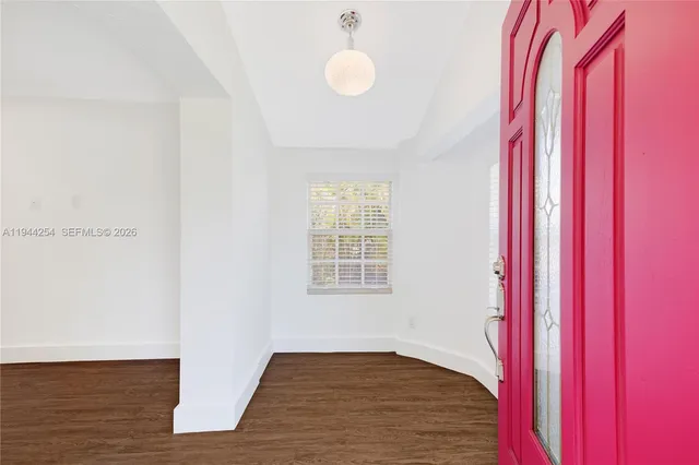 a view of a room with wooden floor and windows