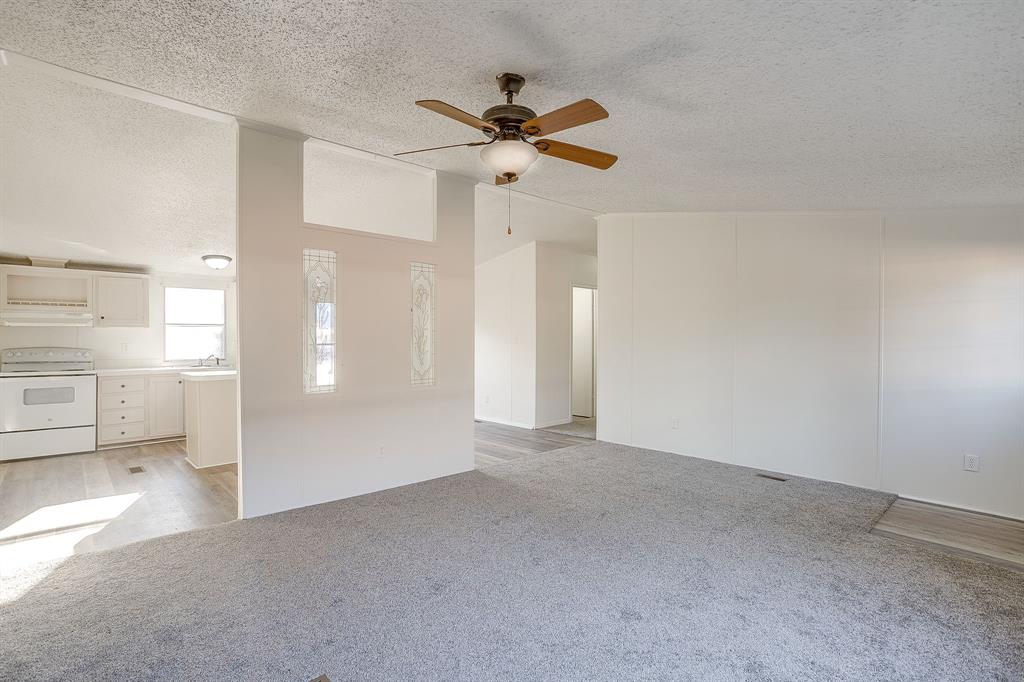 317 6th Street Joshua, TX 76058 - Photo 5 of 36 a view of a livingroom with a ceiling fan and entryway