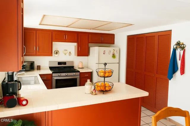 a kitchen with a refrigerator a stove top oven a sink and dishwasher