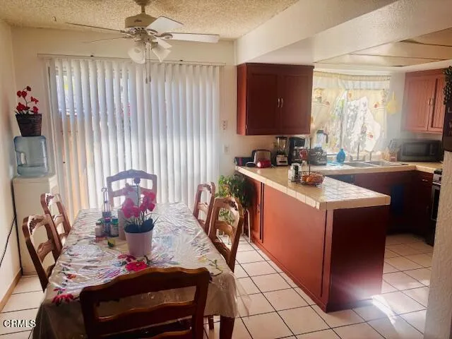 a view of a kitchen with dining table and chairs
