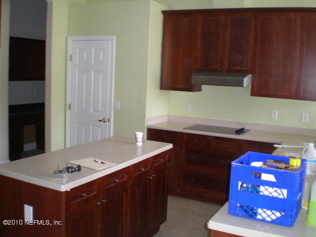 415 Emslie Terrace St. Augustine, FL 32095 - Photo 5 of 13 a kitchen with a sink cabinets and wooden floor