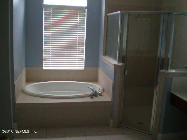 415 Emslie Terrace St. Augustine, FL 32095 - Photo 7 of 13 a bath tub sitting next to a window