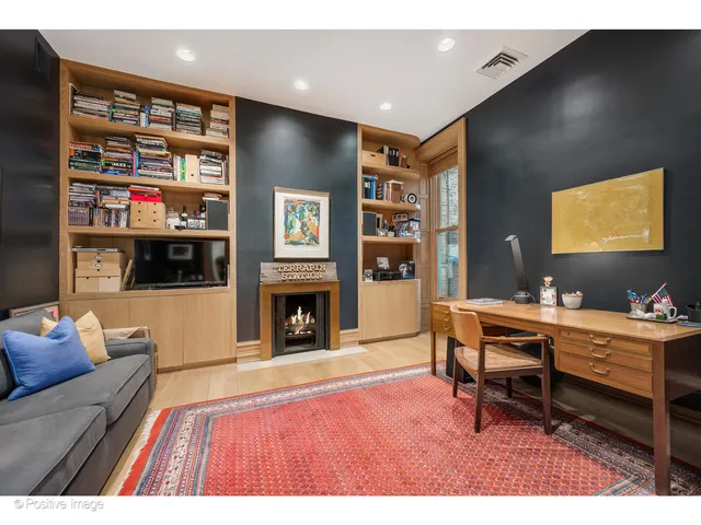 a kitchen with stainless steel appliances granite countertop a stove a refrigerator a kitchen island a dining table and chairs