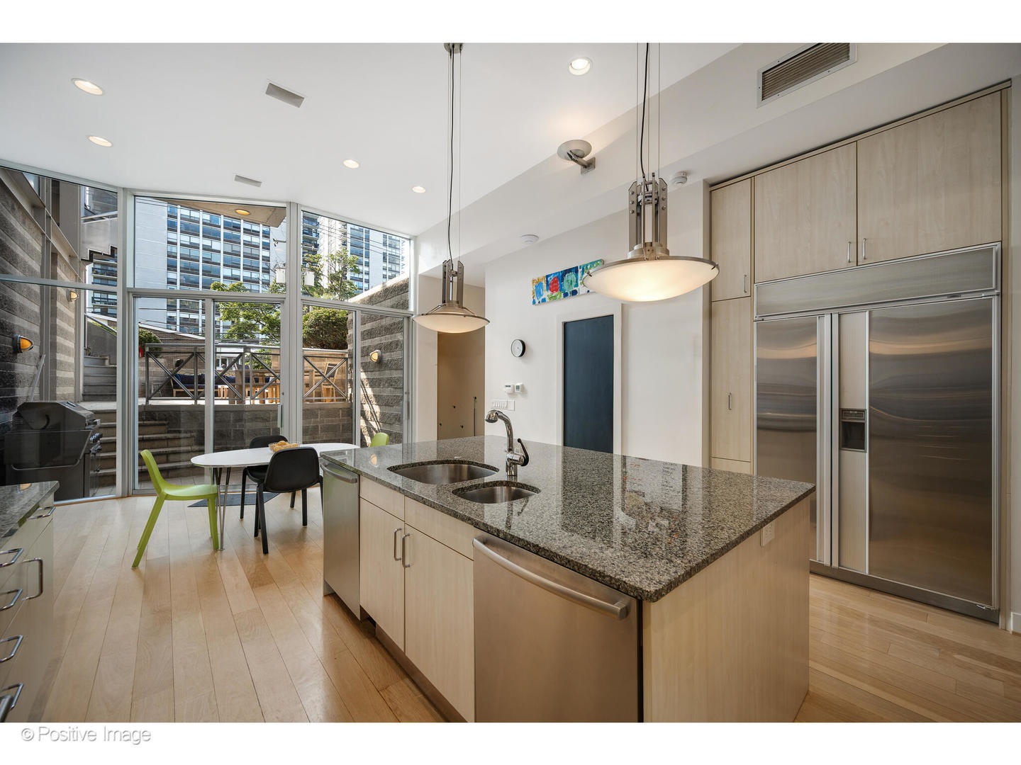 1434 North Dearborn Street Chicago, IL 60610 - Photo 16 of 67 a kitchen with stainless steel appliances granite countertop a stove a refrigerator a kitchen island a dining table and chairs